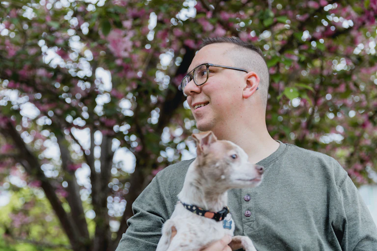 Autistic man holds his dog
