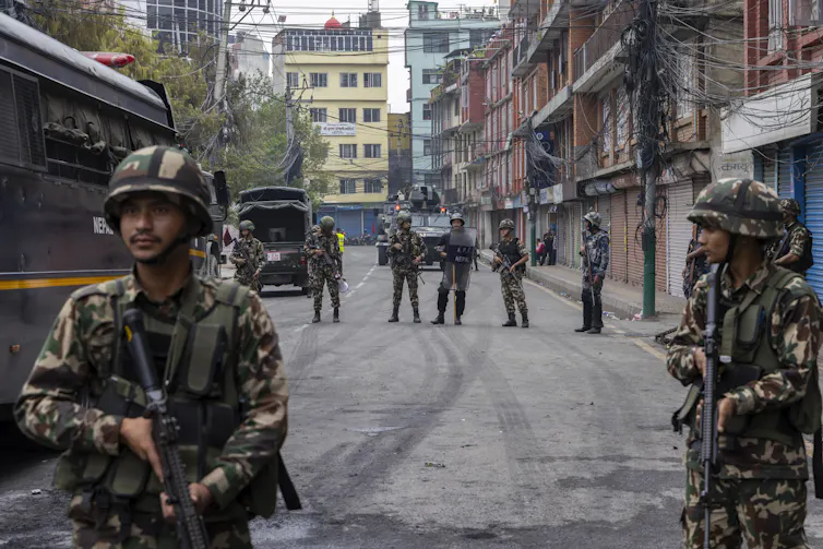 Nepalese troops standing guard on a street in Kathmandu.