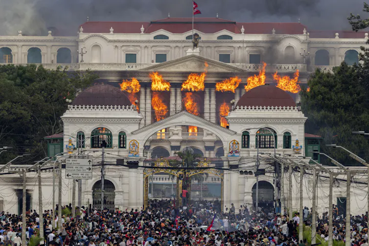Fire and smoke rise from a government building in Kathmandu.