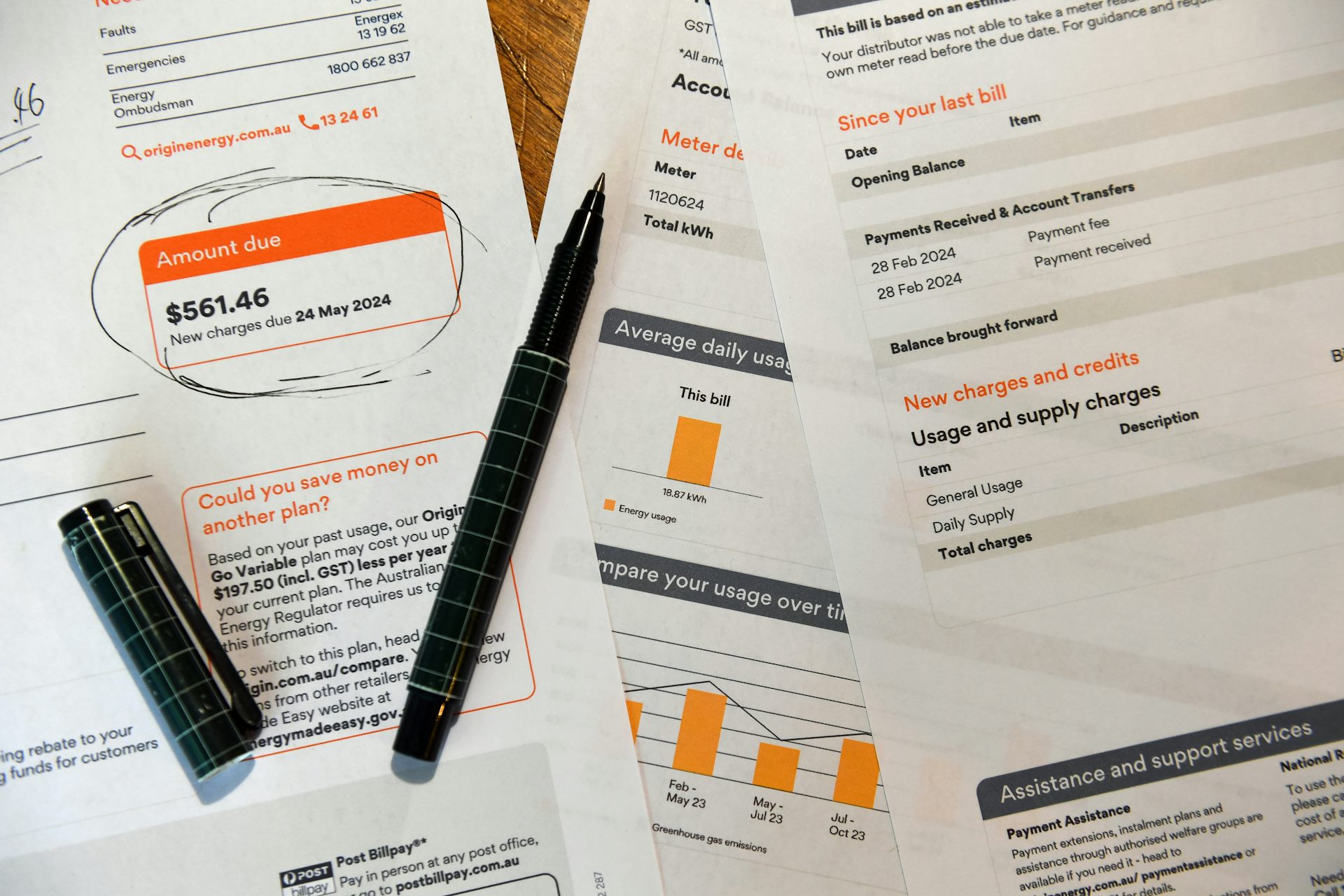 Electricity bills and a pen lying on a table
