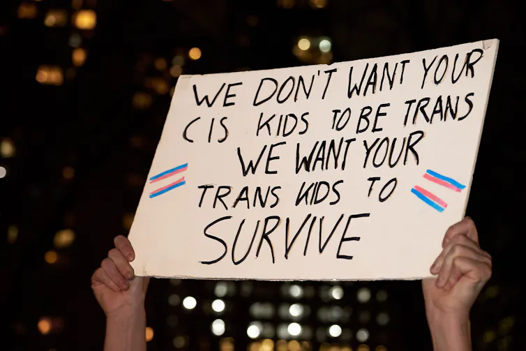 A protest sign saying, We don't want your cis kids to be trans, we want your trans kids to survive