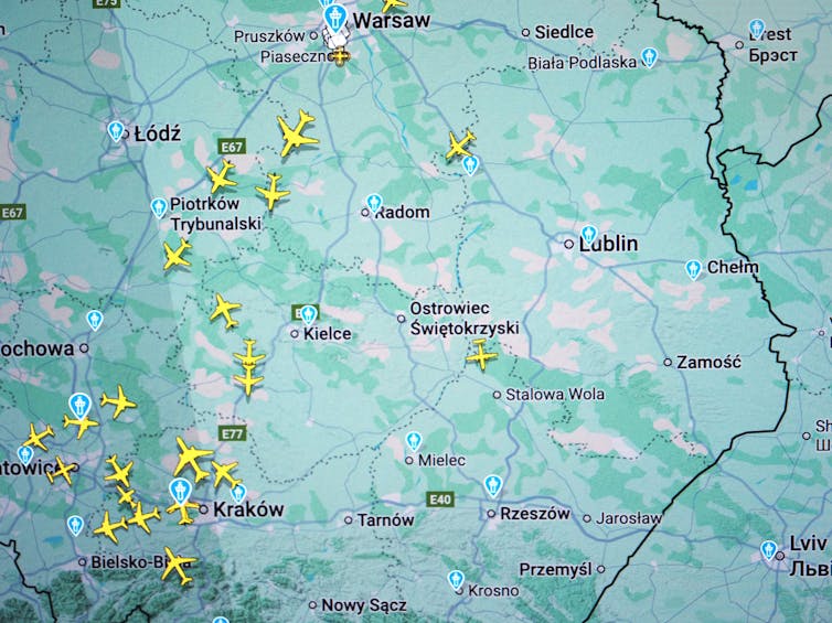 A screen shows small yellow airplanes over the west of a map.