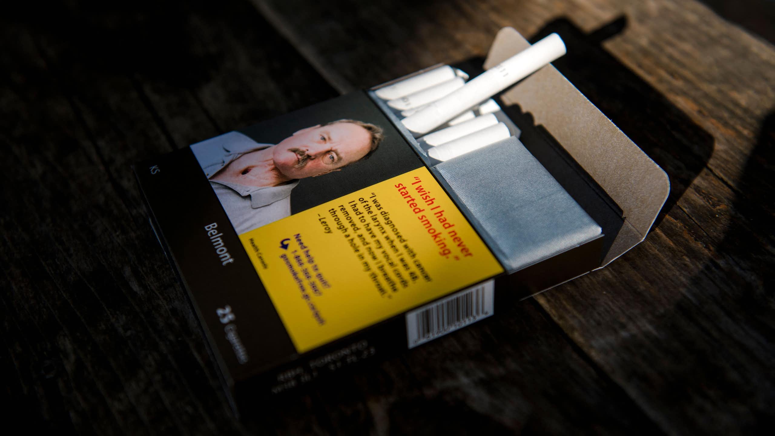 A pack of cigarettes with an image of a man expressing regret he started smoking