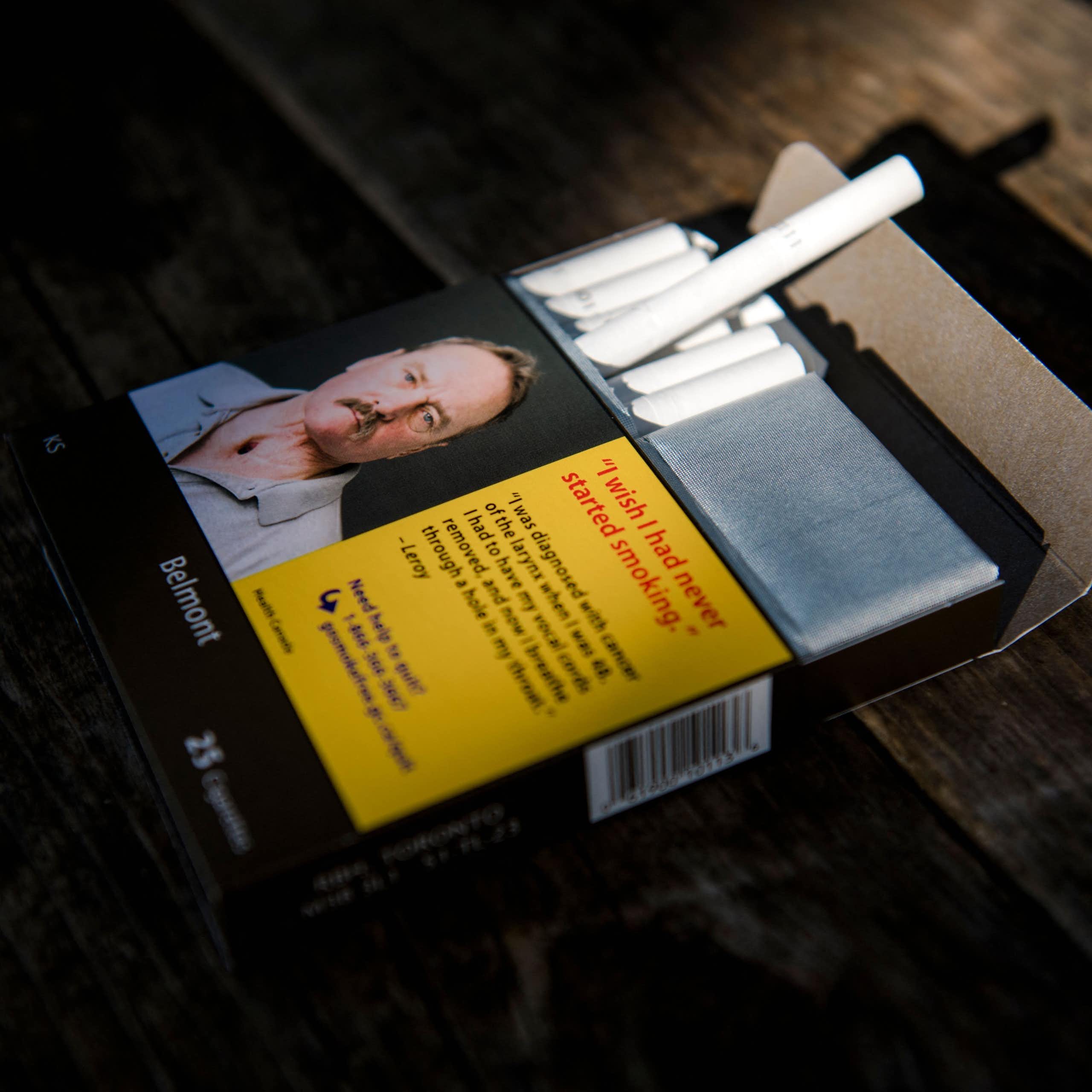 A pack of cigarettes with an image of a man expressing regret he started smoking