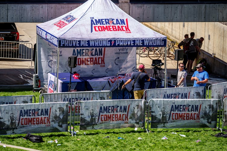 A white tent appears on a college campus.