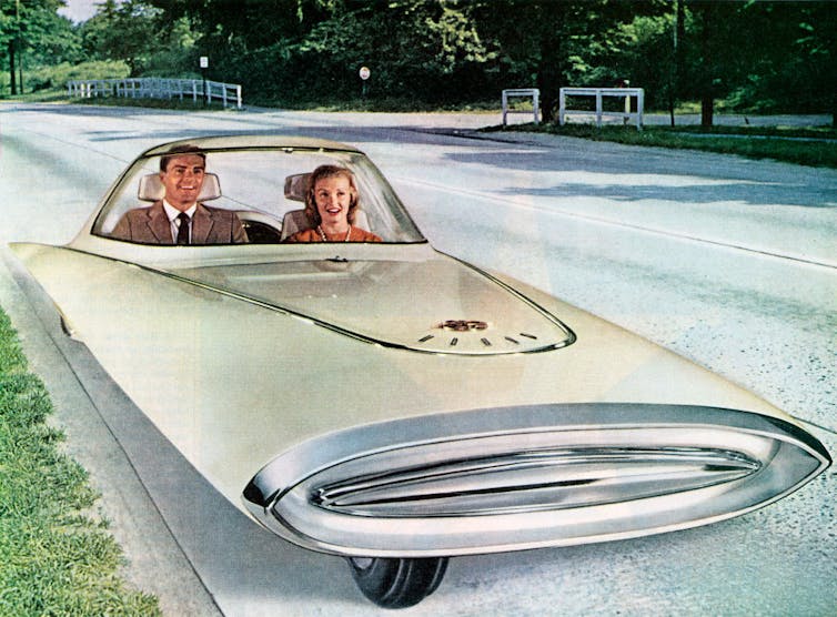 Artist impression of a self-driving car from 1960s, man and woman sitting in a three wheeled car.