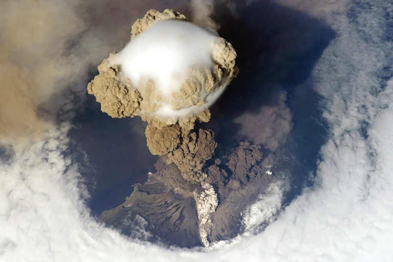 A bulbous volcanic eruption seen from space.