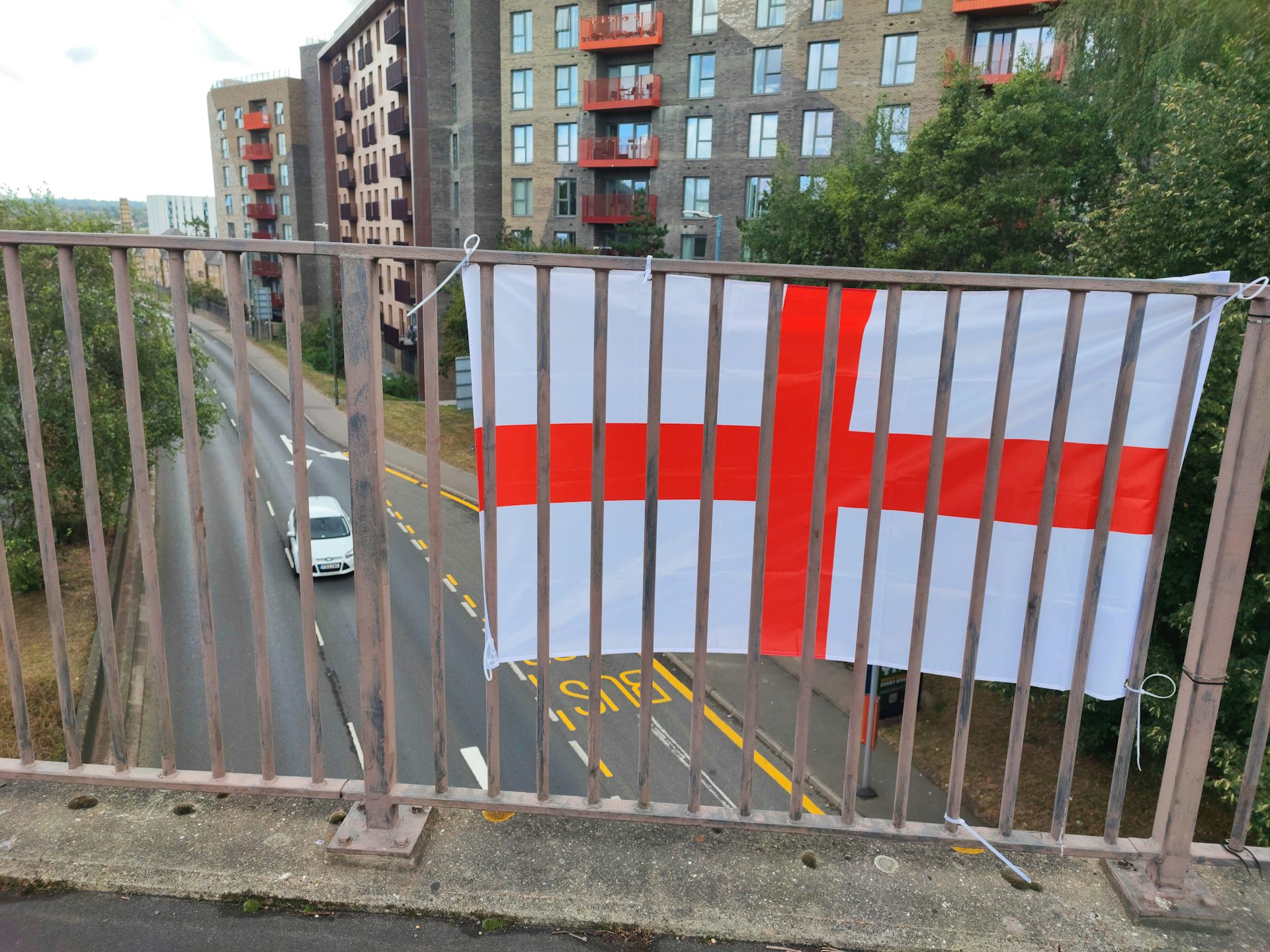 A St George's flag hung next to a road.