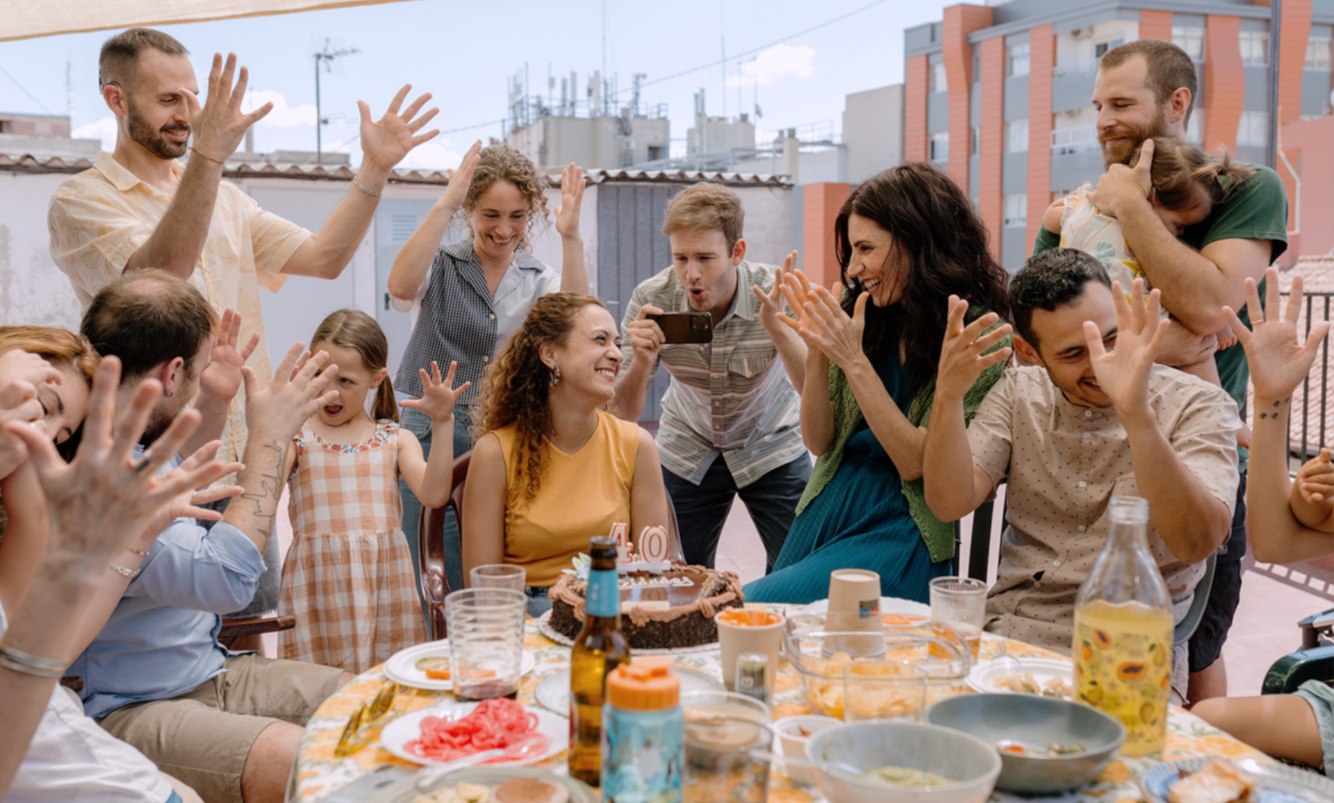 A group of people signing at a party. 