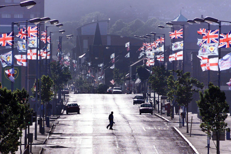 Union and unionist flags lining a quiet street.