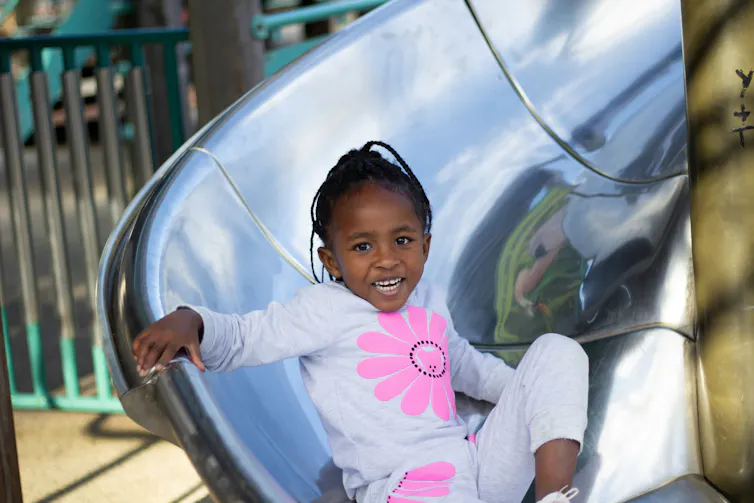 A child at the bottom of a slide.