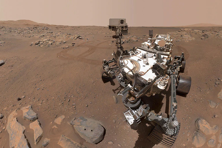 The Mars Perseverence rover sitting on the surface of Mars.