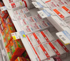 Acetaminophen and other pain relievers on a drugstore shelf.