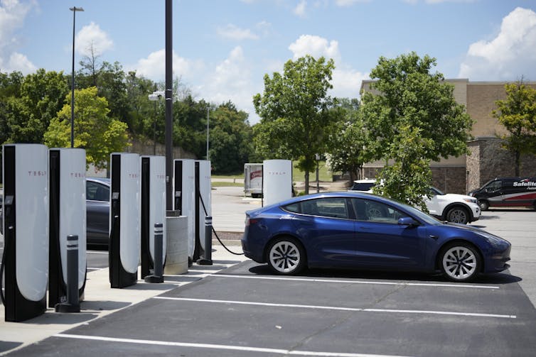 An electric vehicle charging at a station