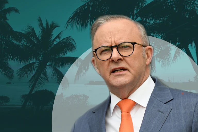 Composite image of a man wearing glasses against ocean and palm trees