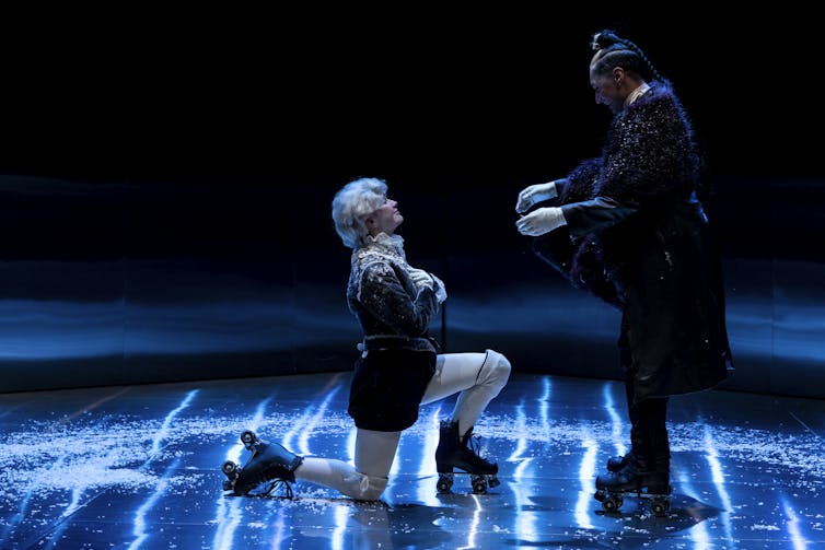 Production image: two actors on roller skates.