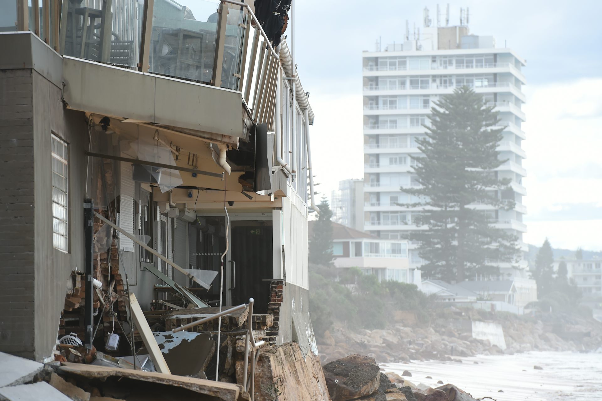 damaged buildings next to ocean