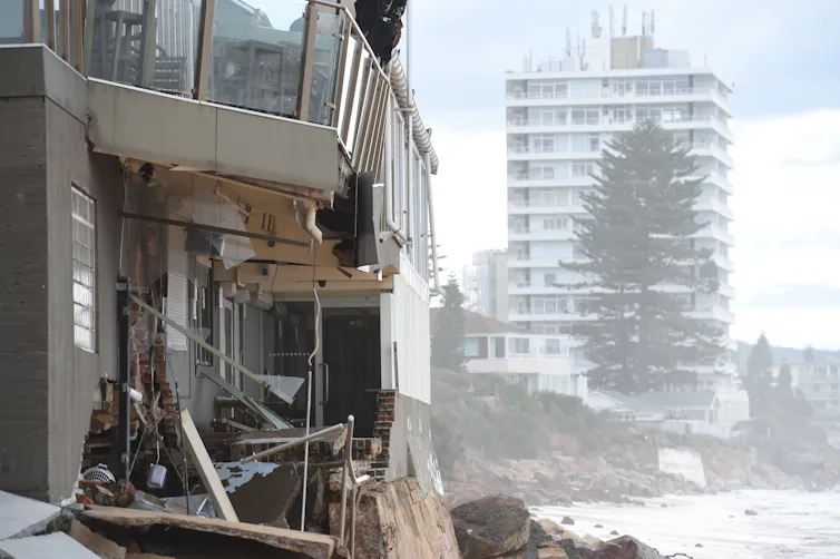 damaged buildings next to ocean