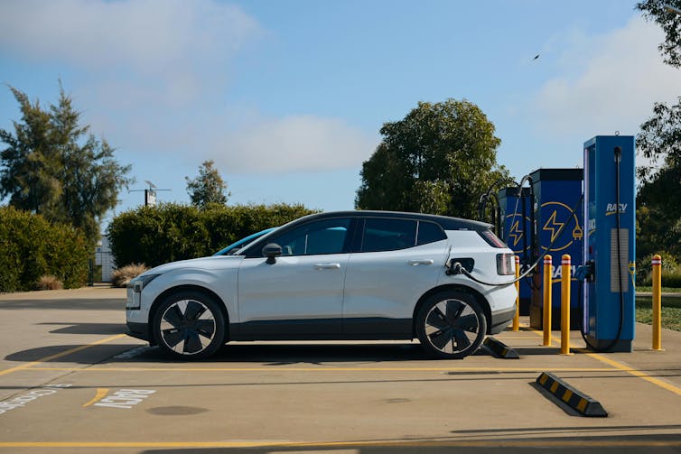 An electric SUV plugged into a car charger in country Victoria.