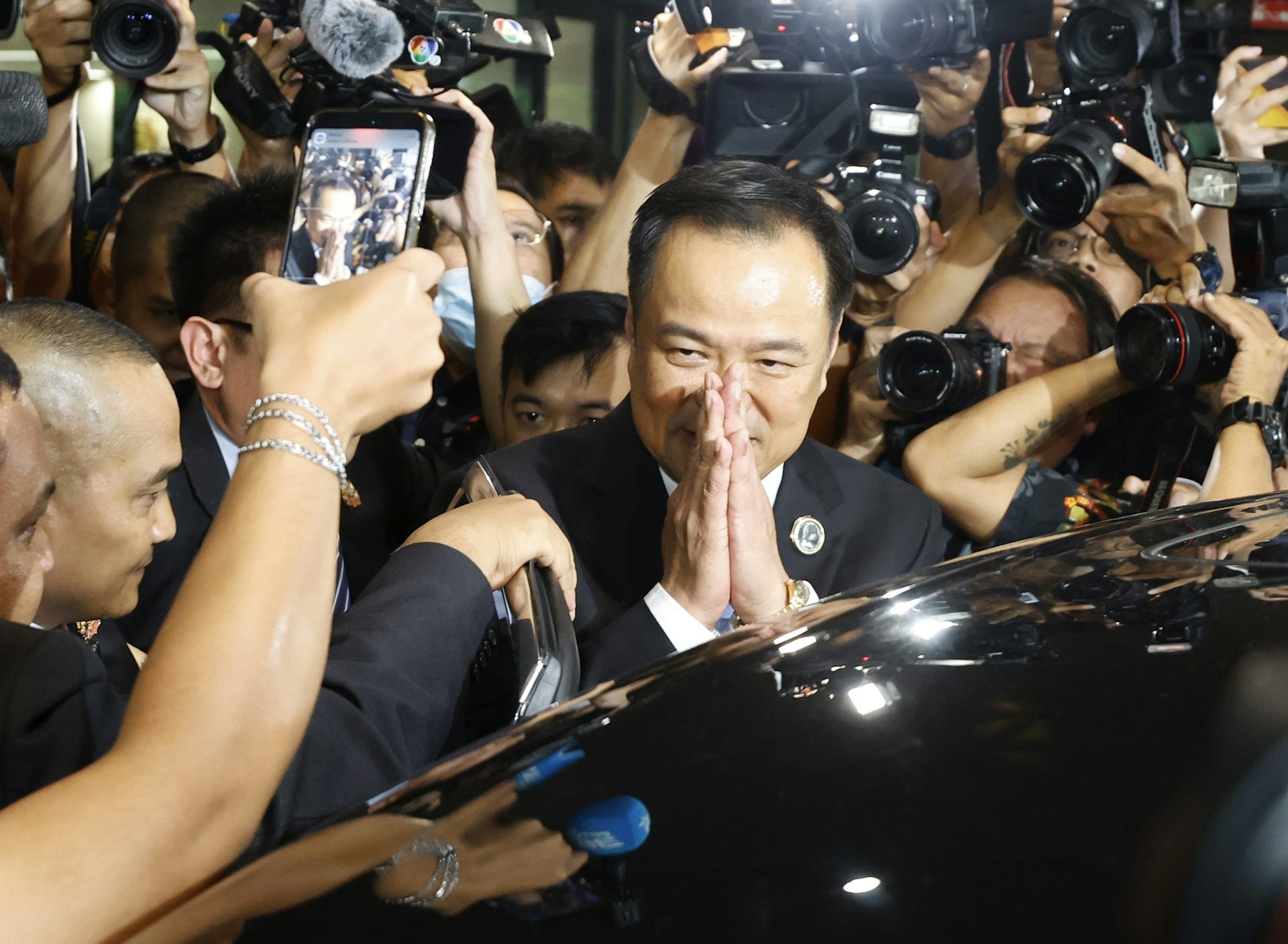 Anutin Charnvirakul greets reporters.