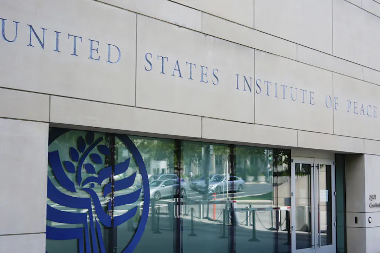 The words The United States Institute of Peace are etched in stone over a doorway.