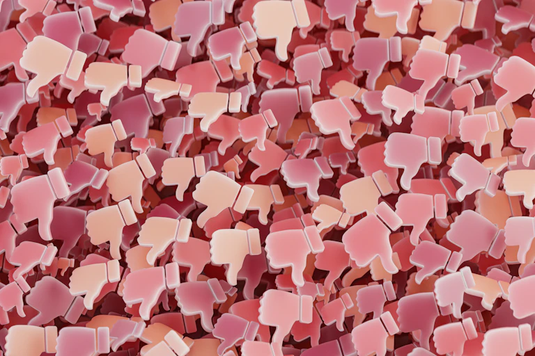 A background of pink social media thumbs-down.