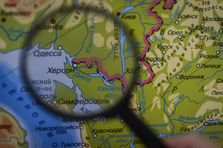 Magnifying glass over a map displaying parts of southern Ukraine as Russian territory