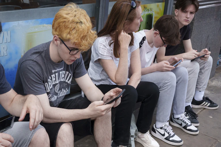 Young people looking at their phones