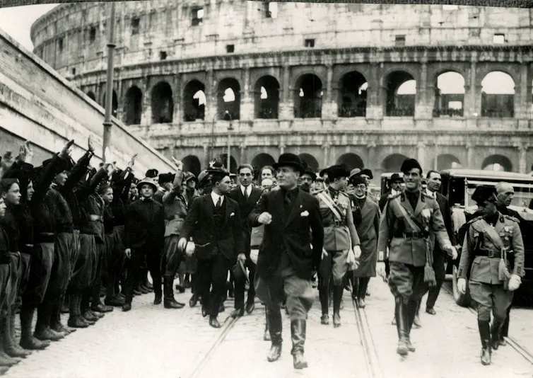 Black and white photo, in front of the colosseum.