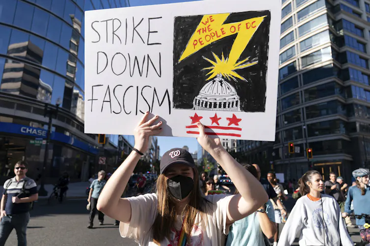 Sign reads 'strike down fascism'.