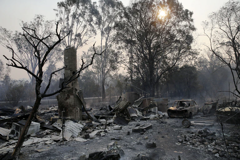 The ruins of a house seen smouldering near Taree, New South Wales