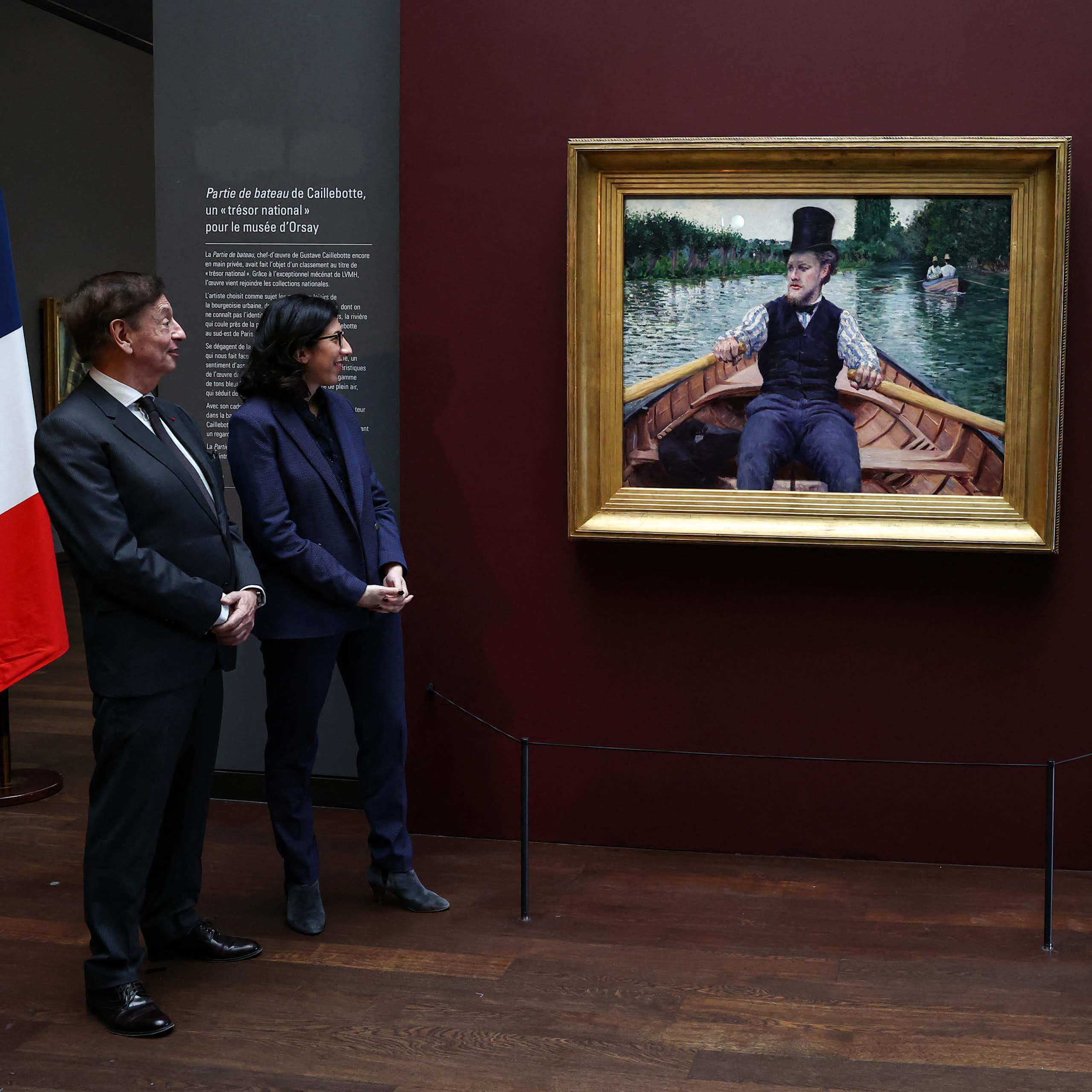 Jean-Paul Claverie, the adviser to LVMH chairman Bernard Arnault; Rima Abdul-Malak, the then French minister of culture; and Christophe Leribault, president of the Musée d'Orsay, stand in front of Gustave Caillebotte's "La Partie de bateau" (The Boating Party) following its arrival at the museum in Paris in 2023.