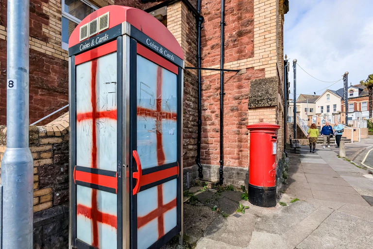 A phone box painted on two sides with St George's crosses.