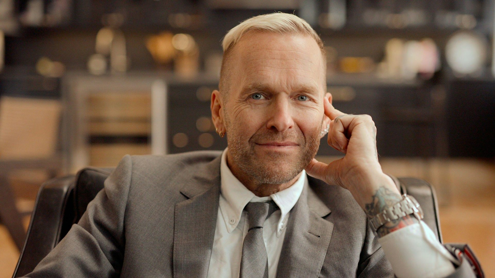 A man with thinning pale hair smiles.