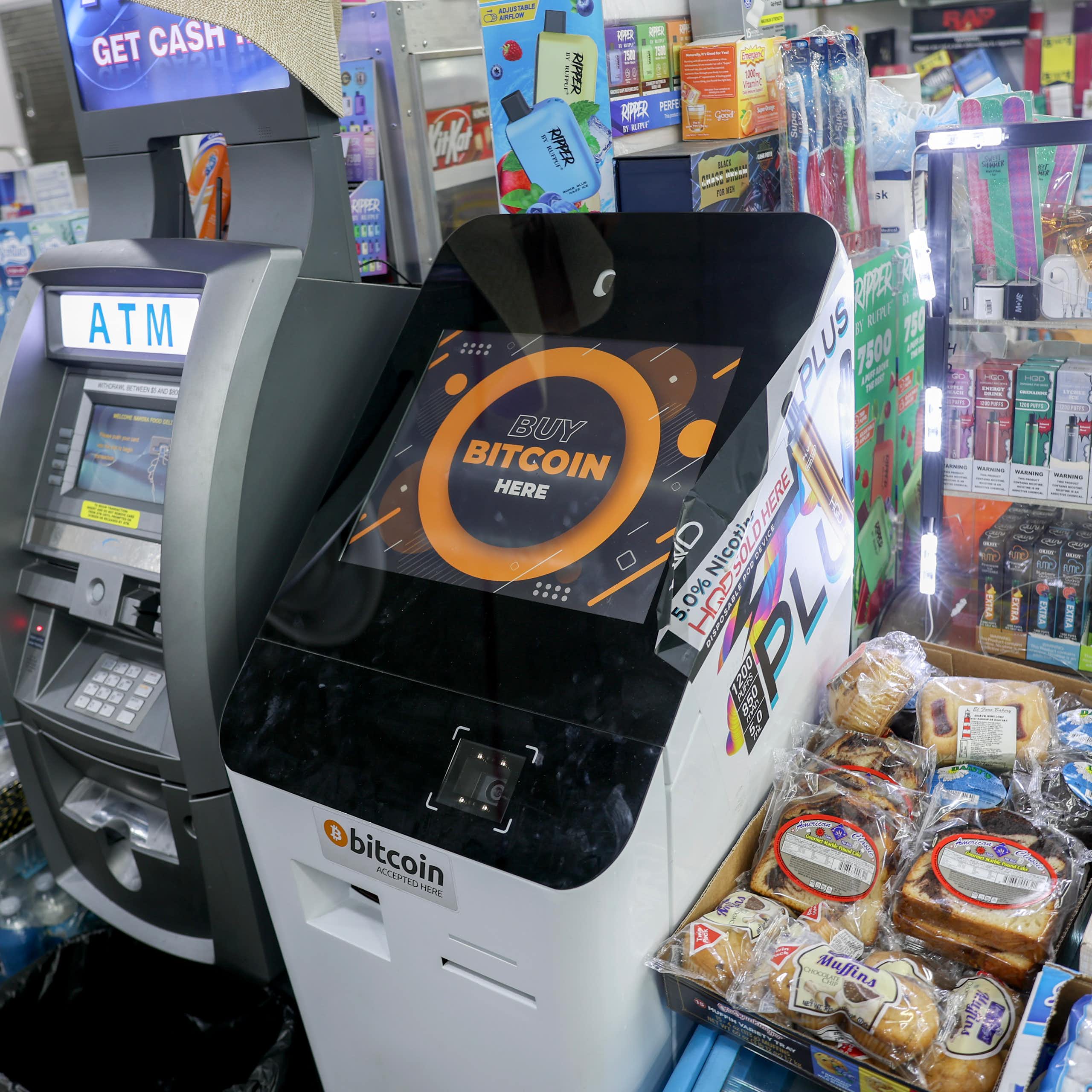 two side-by-side machines with sceens and keypads amidst shelves full off small items