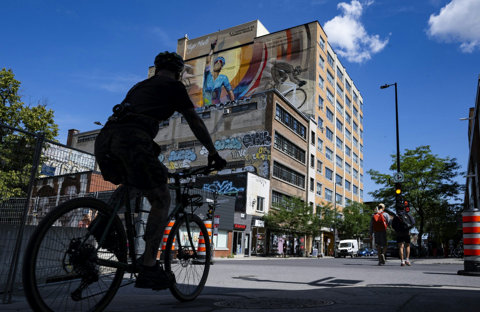El ciclista pasó al ciclista mural con un puño elevado