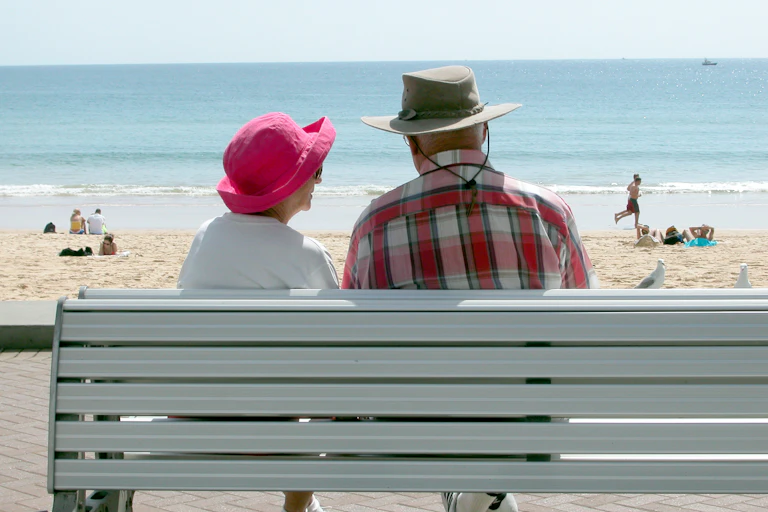 A couple of Australian senior citizens, on Manly beach, Sydney..
