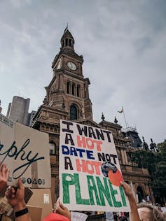 A person holding up a sign at a climate protest in Sydney that reads: