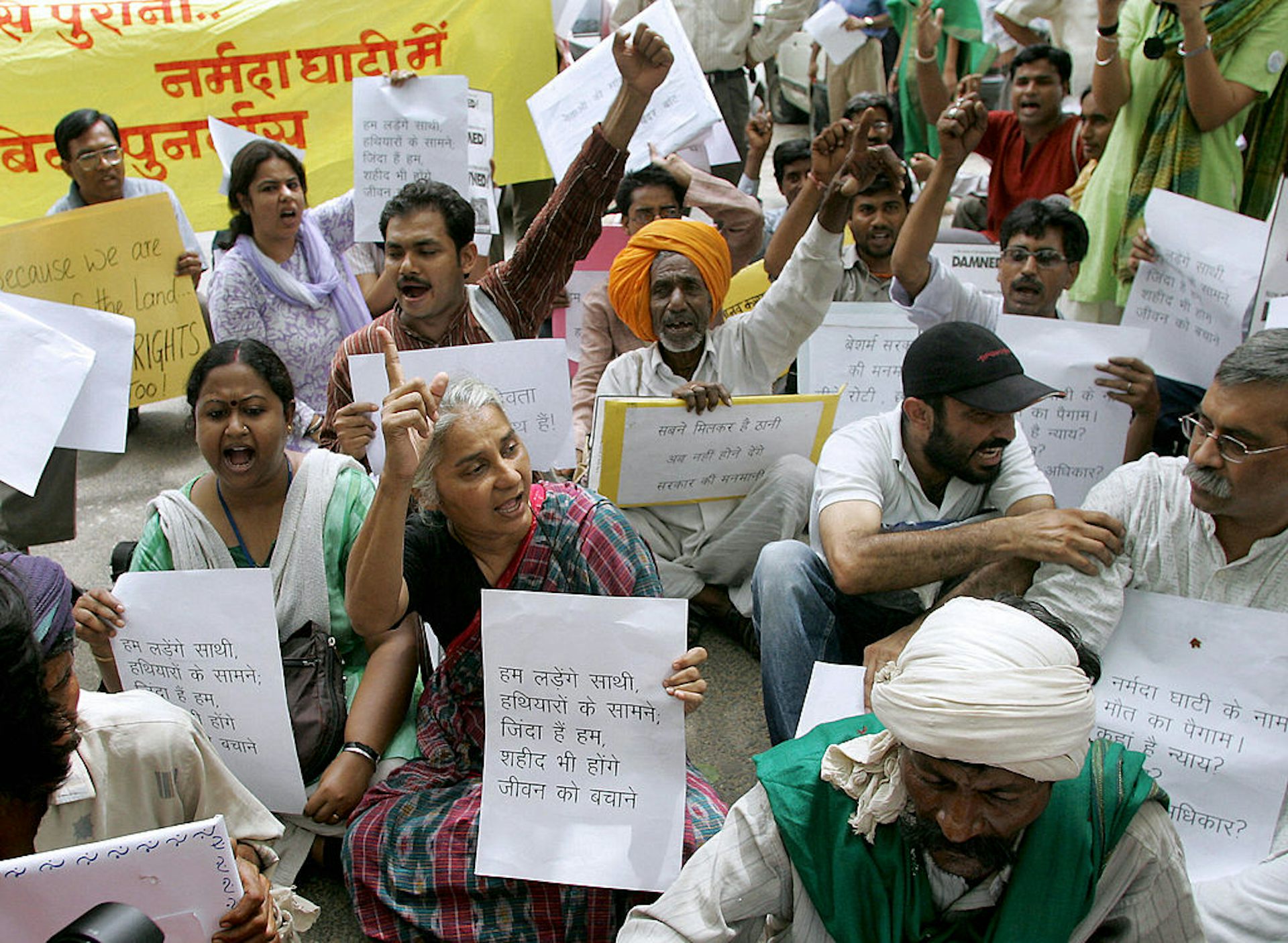 A group of people holding posters, some raising their fists