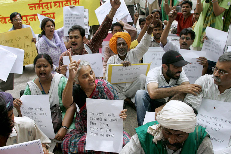 A group of people holding posters, some raising their fists