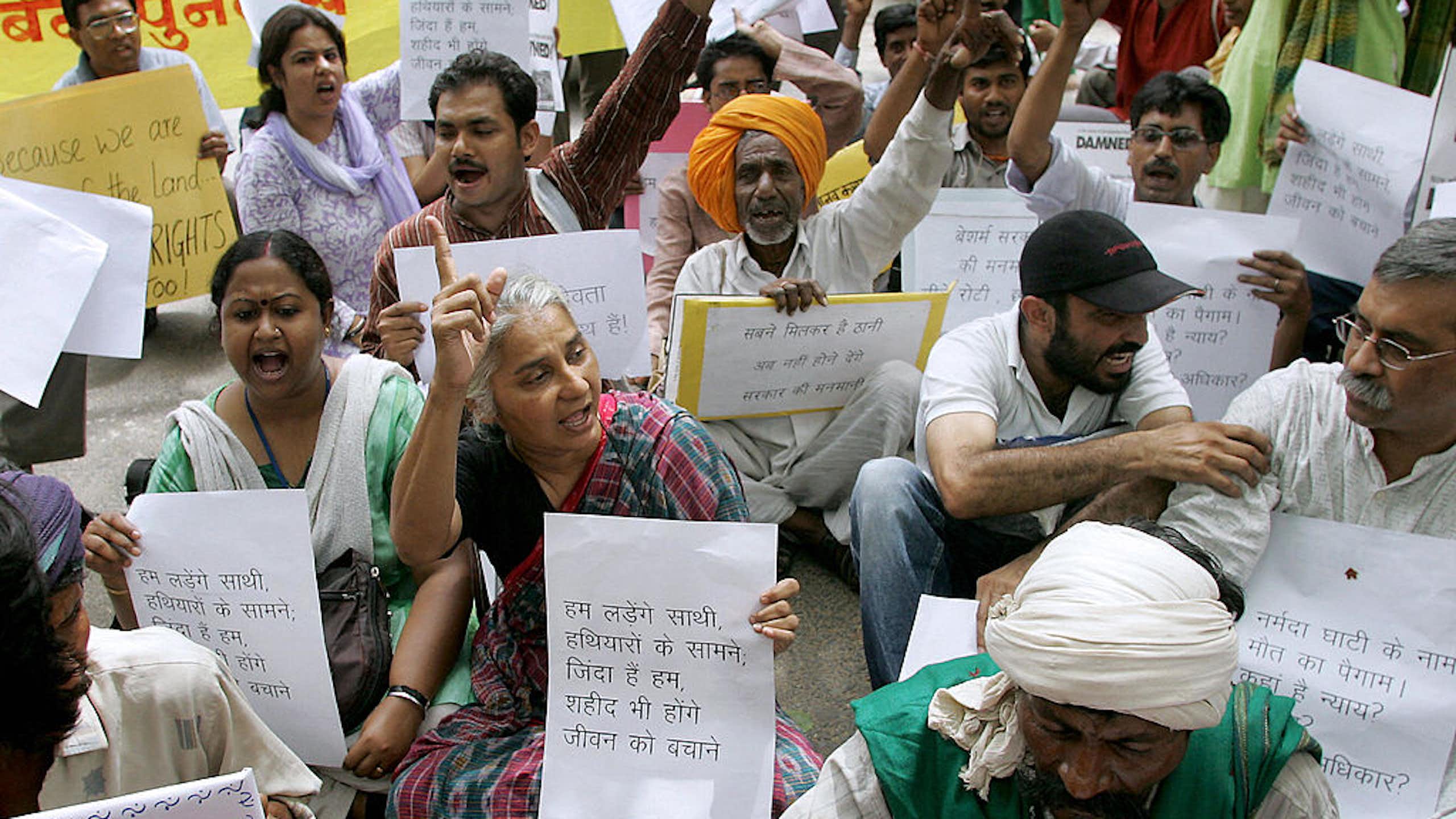 A group of people holding posters, some raising their fists