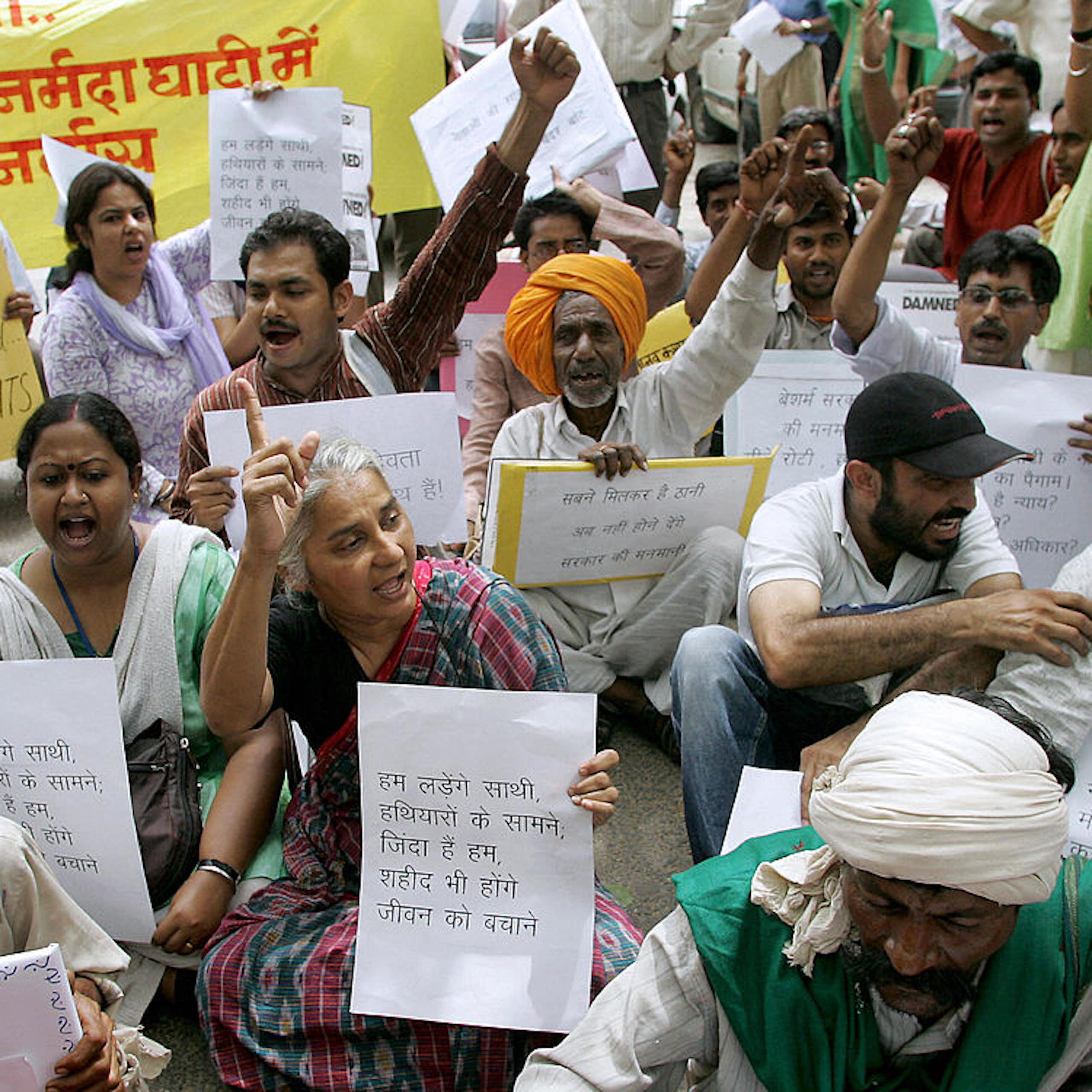A group of people holding posters, some raising their fists