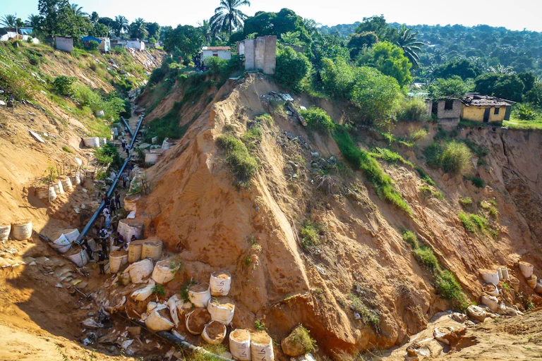 Brown sand and a gully in a village