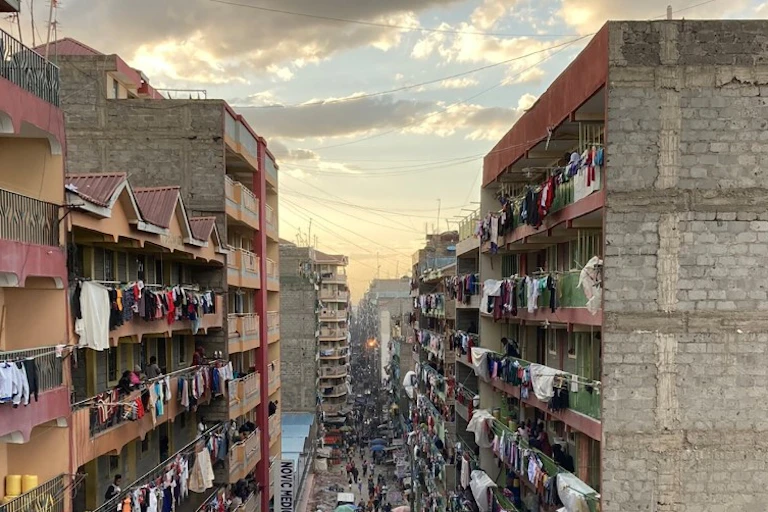 A narrow street lined with residential highrises on either side