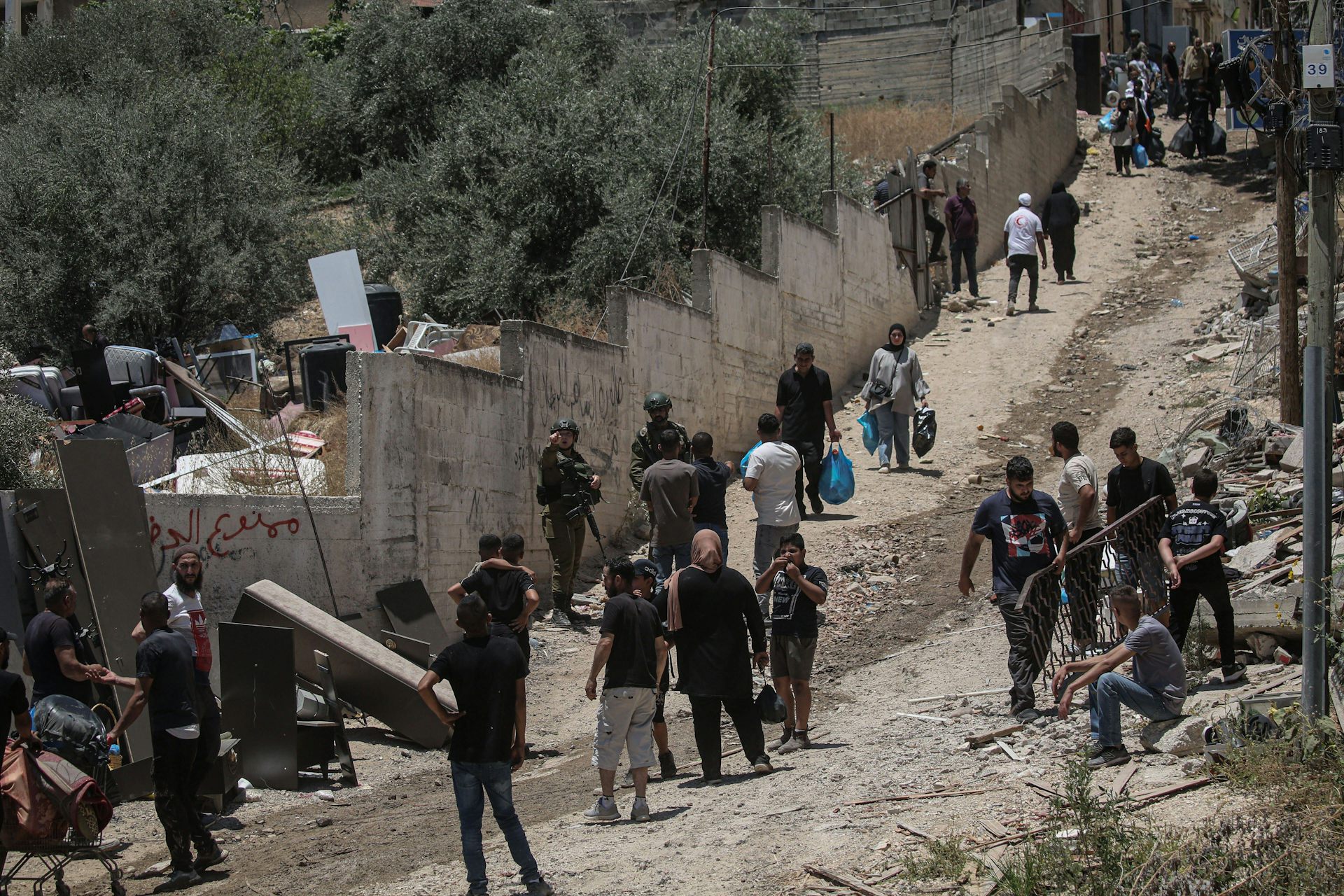 People taking their belongings out of deamaged buildings in Tulkarem, northern West Bank.