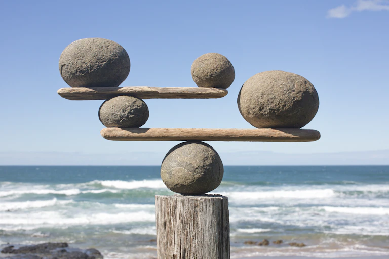 stones of various sizes balance on boards