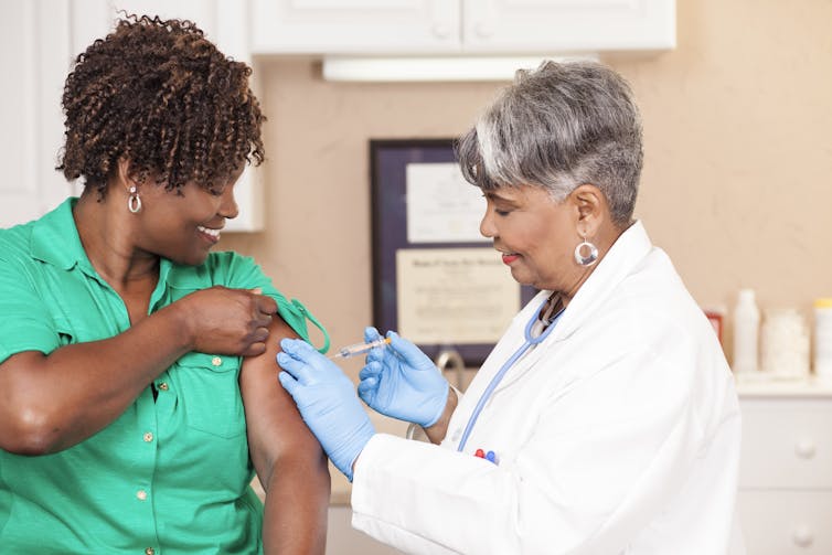Patient gets a vaccine from a doctor.