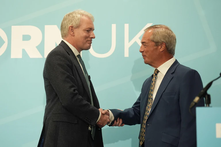 Danny Kruger shaking hands with Nigel Farage.