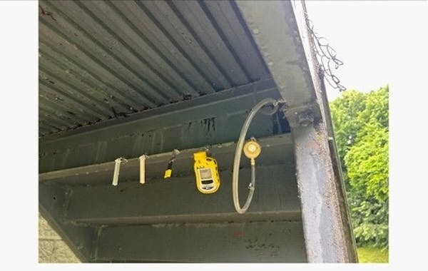 Some yellow and black equipment is attached under an overhang.