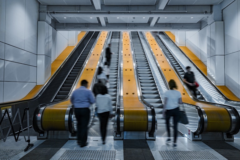 Sydney commuters riding an escalator